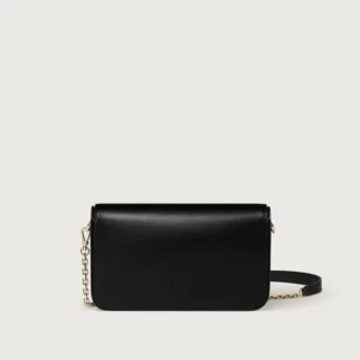 Bolso de cadena mini, Double C de Cartier – Piel de becerro negra, acabado en oro y esmalte negro – Cartier