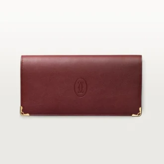 Cartera internacional con fuelles, Must de Cartier – Piel de becerro burdeos, acabado dorado – Cartier