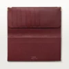 Cartera internacional con fuelles, Must de Cartier – Piel de becerro burdeos, acabado dorado – Cartier