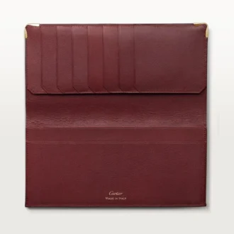 Cartera internacional con fuelles, Must de Cartier – Piel de becerro burdeos, acabado dorado – Cartier