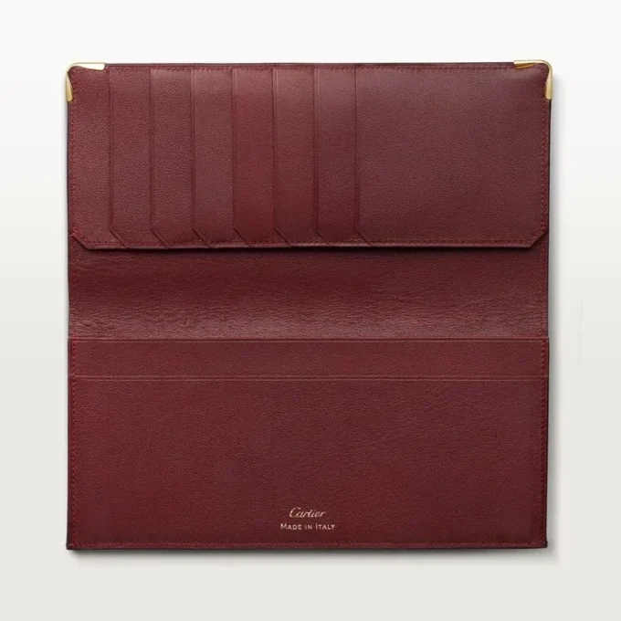 Cartera internacional con fuelles, Must de Cartier – Piel de becerro burdeos, acabado dorado – Cartier