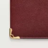 Cartera internacional con fuelles, Must de Cartier – Piel de becerro burdeos, acabado dorado – Cartier